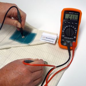 testing an earthing bed sheet with an Orange Peak Meter Multimeter with probes