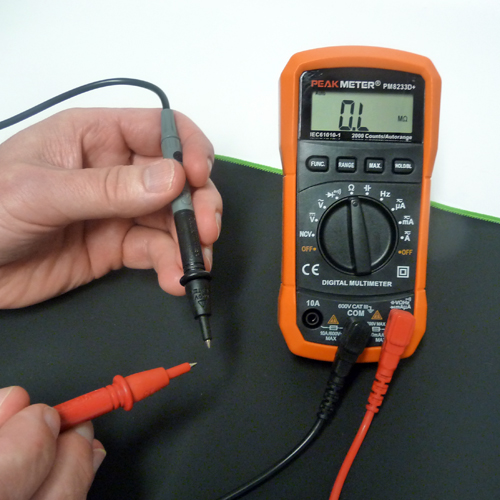 Orange Peak Meter Multimeter and probes on an earthing mat